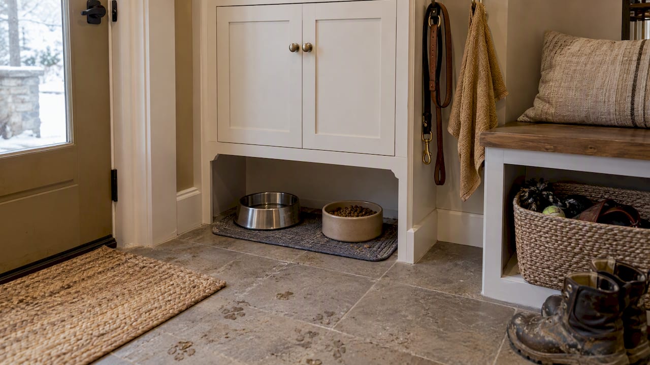 Pet bowls and leash in mudroom storage nook