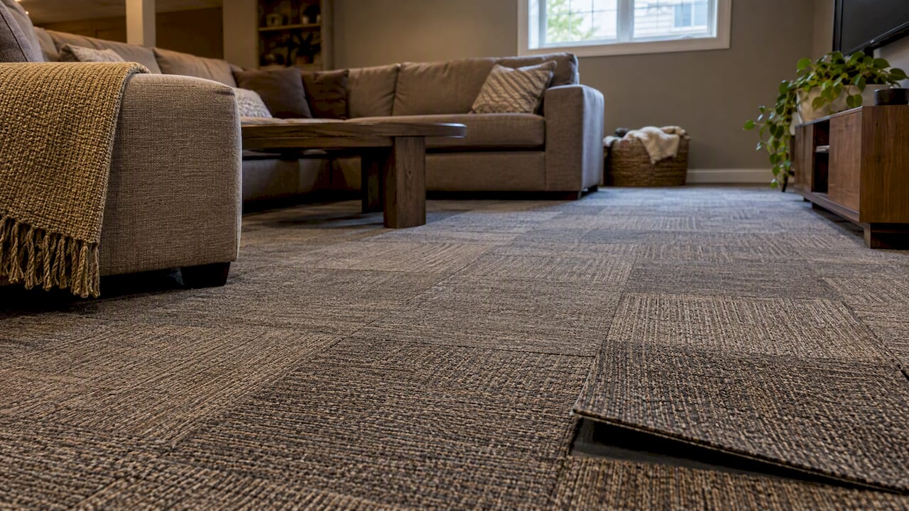 Modular carpet tiles across a basement lounge floor