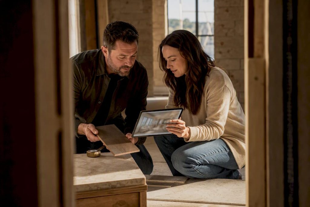 Homeowner reviewing design choices with custom builder